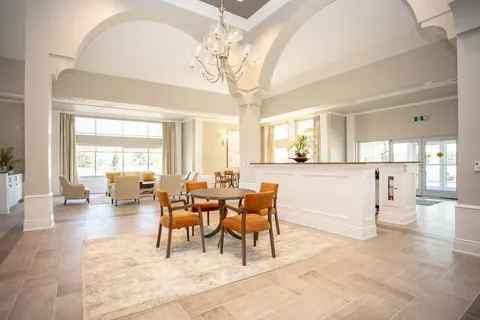 Bright seating area with a table, chairs and a reception counter