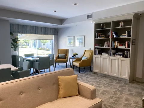 Sitting area with a sofa, chairs, tables and bookshelves