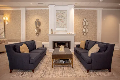 Two dark sofas facing a coffee table and fireplace