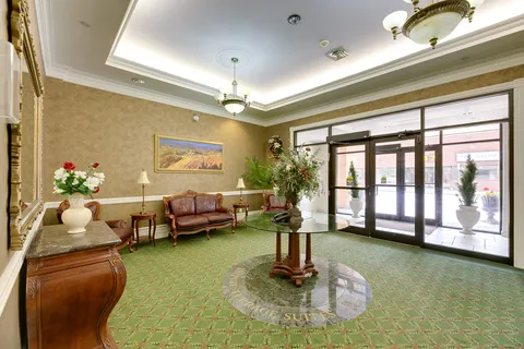 Entrance lobby with leather seating, a round table and glass doors