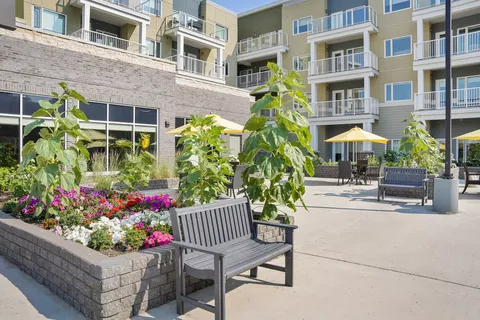 Courtyard with benches, flower beds and apartment balconies