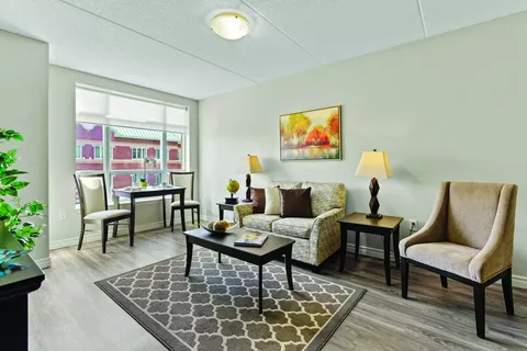 Sitting area with a loveseat, armchair, coffee table and dining table