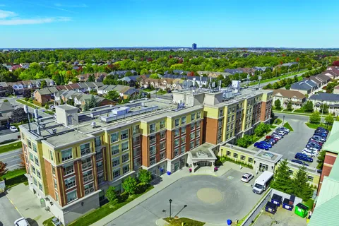 Aerial view of the residence building, entrance drive and parking area