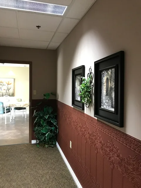 Interior corridor with handrails and framed pictures.