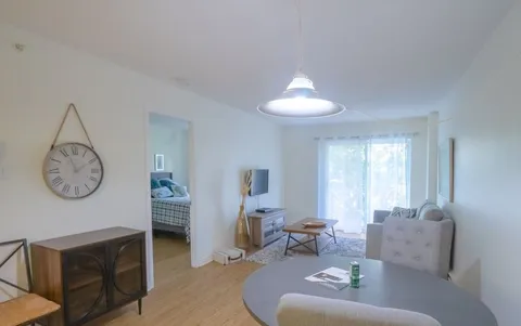 Apartment living and dining area opening onto a balcony.