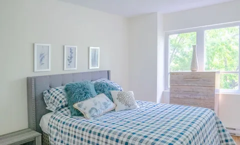 Bedroom with a double bed and wooden dresser.