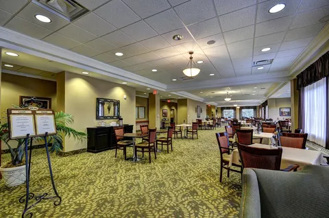 Dining room with upholstered chairs and large windows