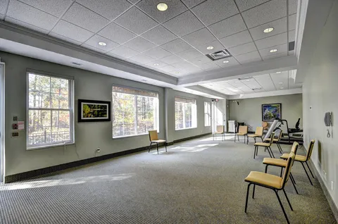 Wellness room with chairs and exercise equipment