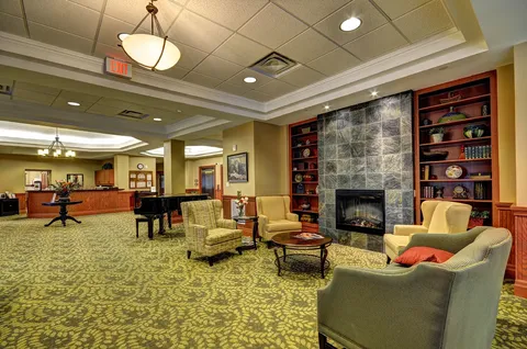 Lobby with fireplace, armchairs and reception counter