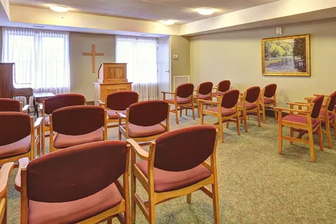 Chapel with rows of upholstered chairs