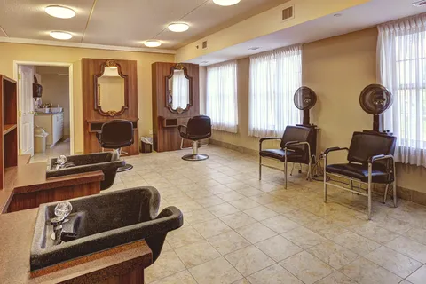 Hair salon with styling chairs and hood dryers