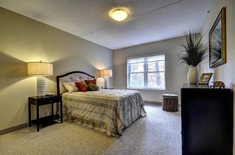 Bedroom with double bed, lamps and window