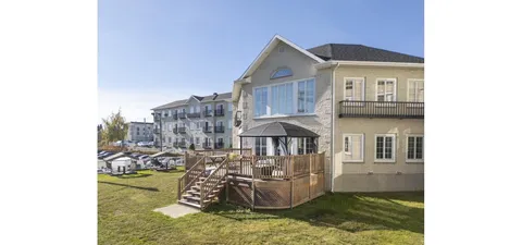 Residence with a gabled roof, balconies and a covered wooden deck