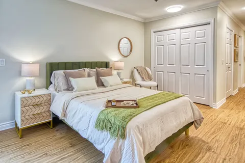 Bedroom with a bed, nightstands and wardrobe doors.