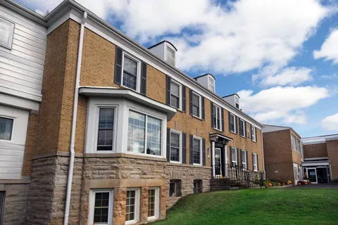 Side of the residence beside a lawn and landscaped garden beds