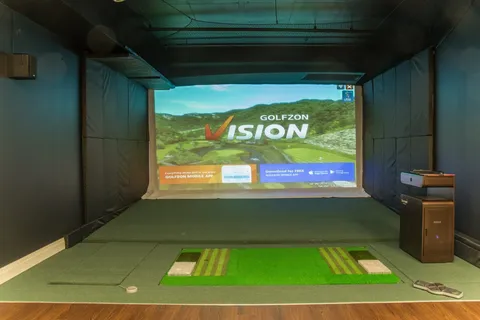 Golf simulator with a projection screen and green hitting mat