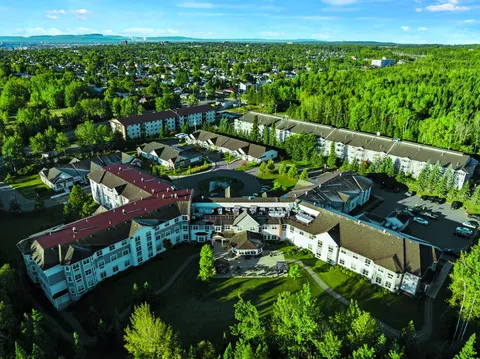 Aerial view of the residence buildings, paved paths, lawns and surrounding trees