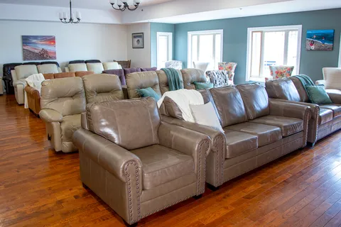 Common room with leather sofas and rows of upholstered chairs.