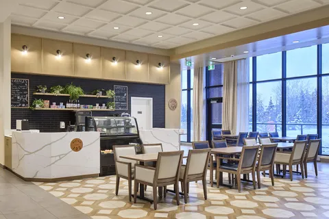 Cafe counter and tables beside large windows