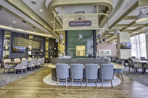 Dining area with round tables and a central service counter