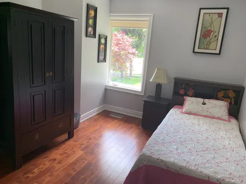 Bedroom with a bed, bedside table and wardrobe.