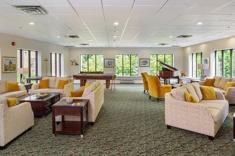 Lounge seating with a grand piano beside large windows