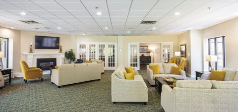 Lounge with sofas, a fireplace and glass doors