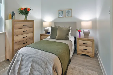 Bedroom with a single bed and wooden storage furniture