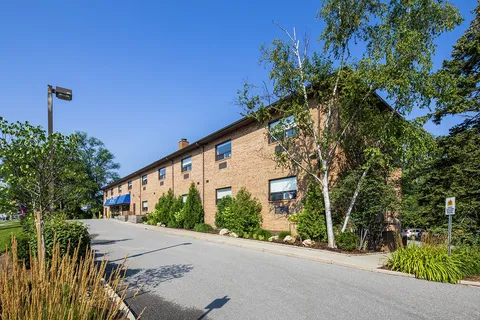 Residence exterior beside a landscaped street entrance