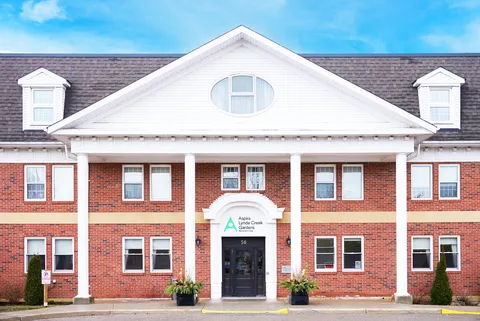 Red-brick facade with white columns and a central entrance
