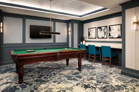 Games room with a pool table and counter seating