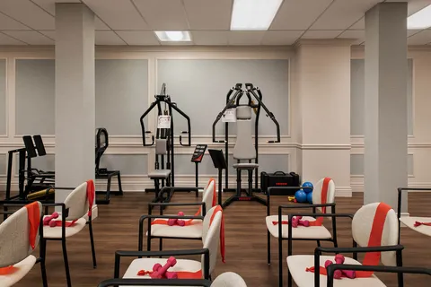 Fitness room with exercise equipment and chairs