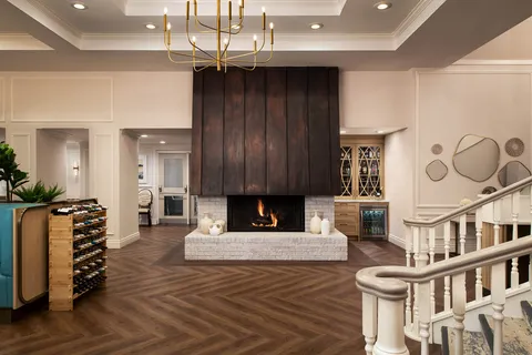 Lobby fireplace beside a curved staircase