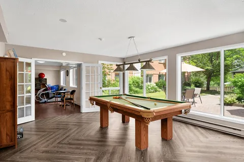 Shared billiards and seating room with large windows overlooking the patio.