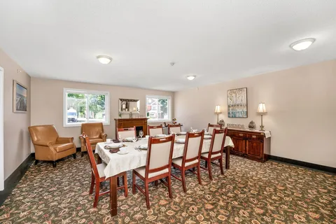 Private dining room with a set table and sideboard.