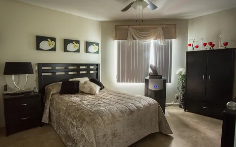 Bedroom with a bed and dark wooden furniture.