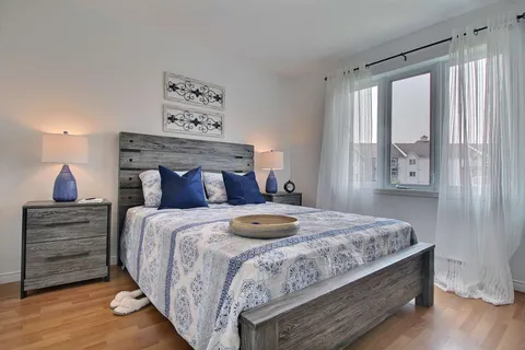 Bedroom with a double bed, bedside tables and a window.