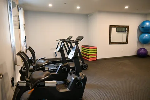 Exercise room with stationary bicycles, step platforms and exercise balls