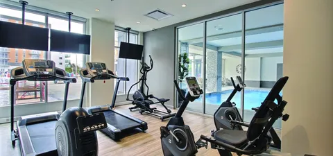 Fitness room with exercise machines and benches.