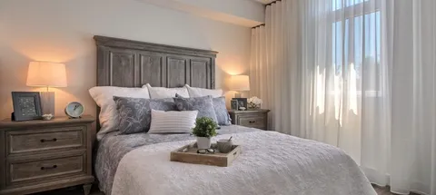 Bedroom with a bed, bedside tables and a window.