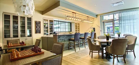 Lounge with chess tables, armchairs and a bistro counter.