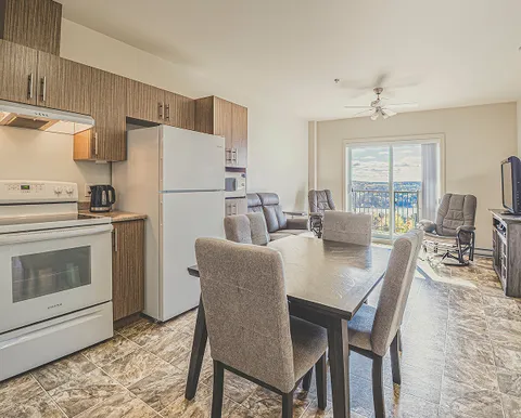 Room with a kitchen, dining table, chairs and a sitting area