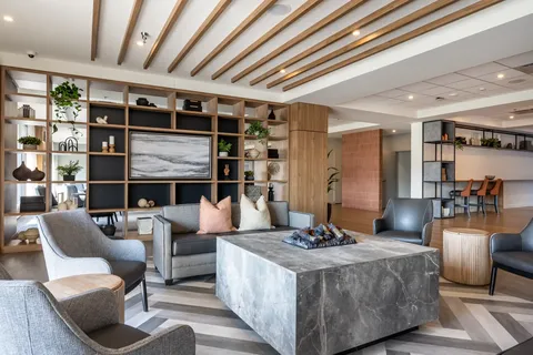 Seating area with a sofa, armchairs and a square fireplace table
