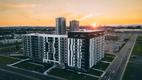 Aerial view of a modern residence beside roads at sunset