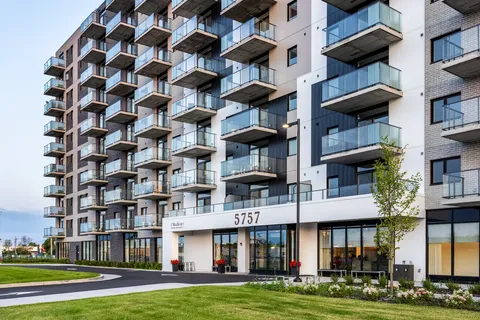 Modern residence with balconies and a covered entrance marked 5757