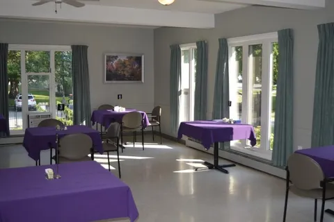 Dining room with purple tablecloths and large windows