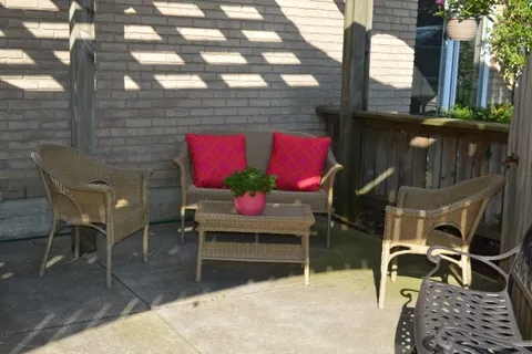 Wicker patio chairs around a small table