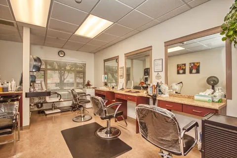 Salon with styling chairs and wall mirrors