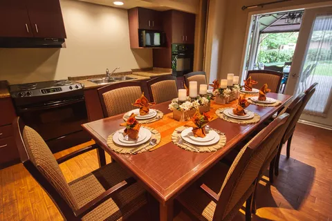 Private dining room with a long table and kitchen