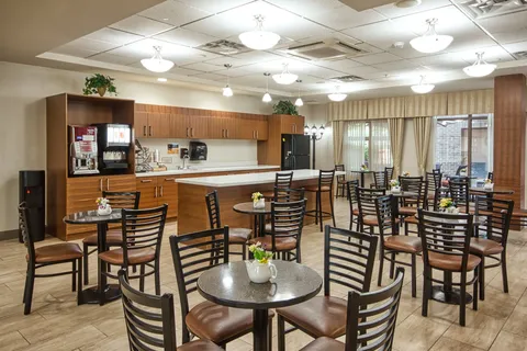 Cafe seating beside a counter and kitchen cabinets